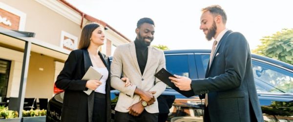 Young People business couple African man and Caucasian woman standing outdoors in a Car Rental